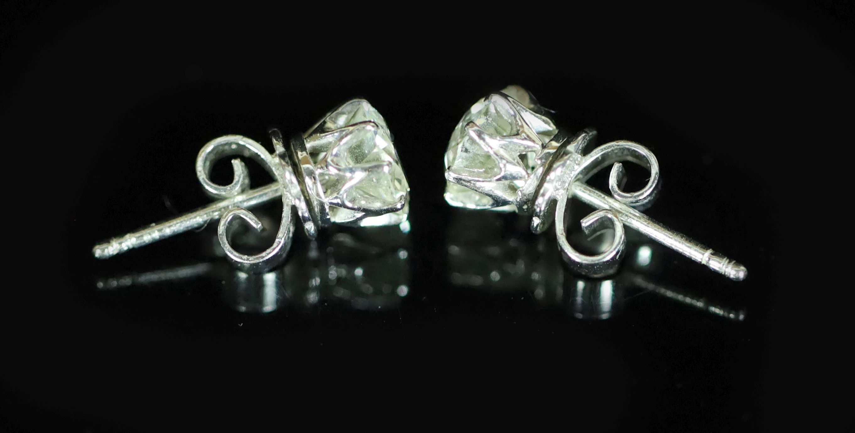 A pair of white gold and diamond stud earrings, the diamonds each approximately 0.75ct,